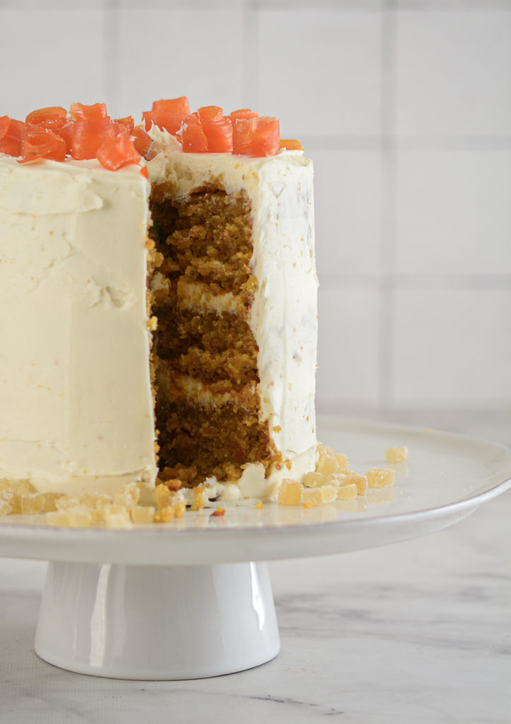 Carrot Ginger Cake with White Chocolate Cream Cheese Frosting with a slice out of it