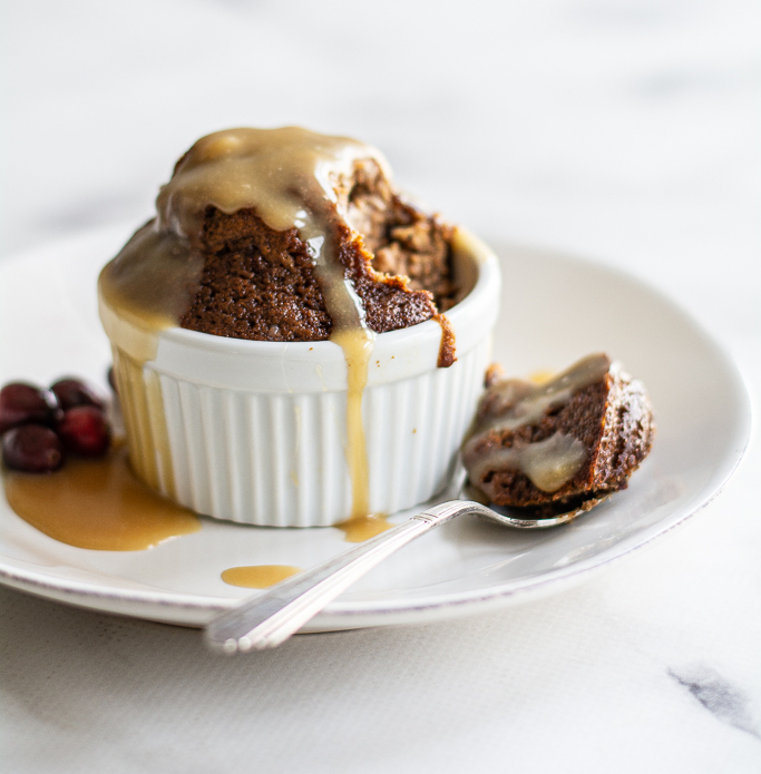 photo of sticky toffee pudding, caramel sauce and a spoon