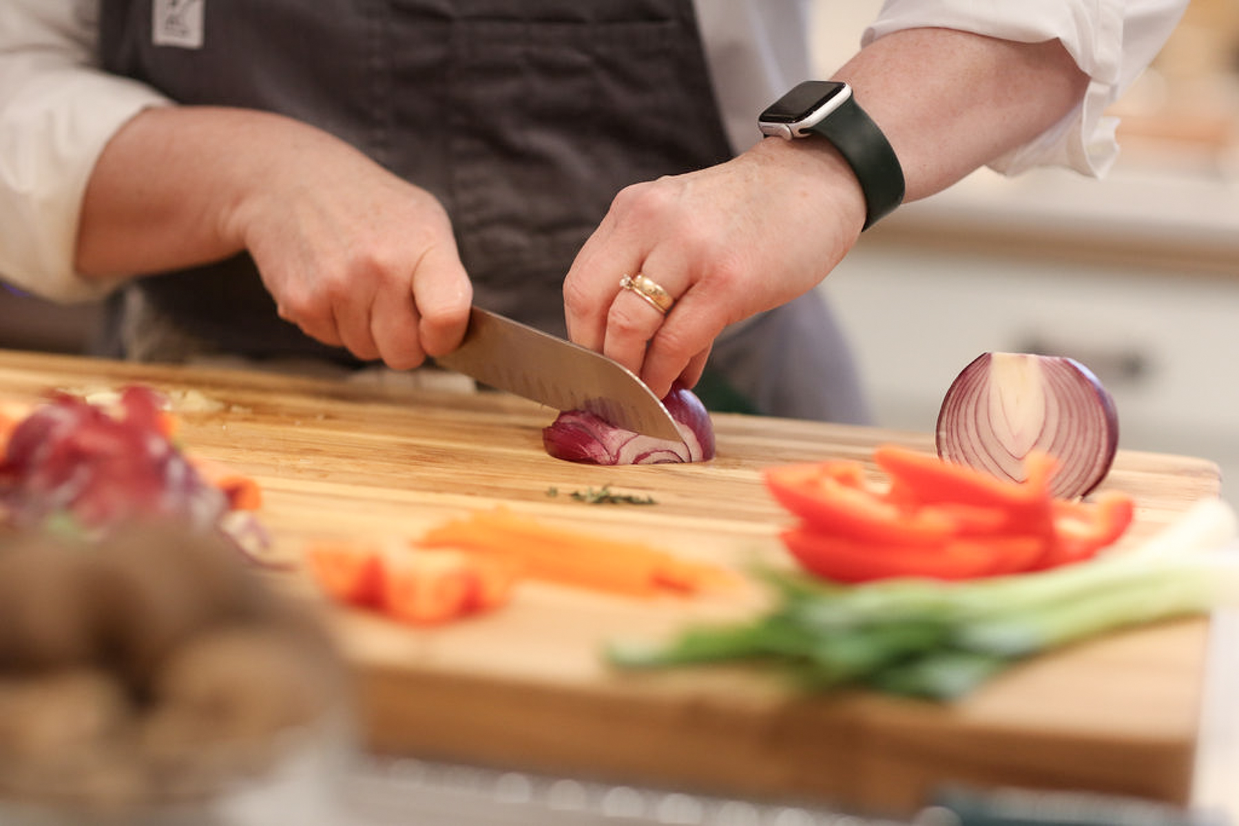 shelagh cutting a red onion teaching knife skills to a cooking class