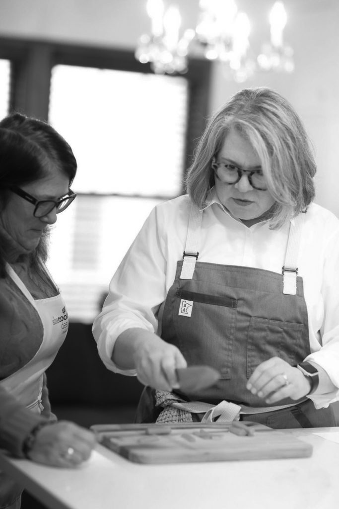 black and white photo of shelagh with cooking class student