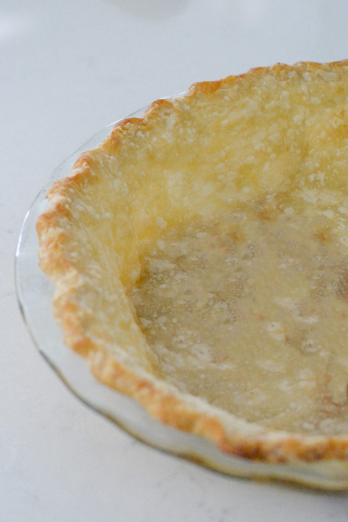 baked pie crust in a glass pie pan