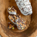 Chocolate Ginger Salami with Hazelnuts sliced in an old wooden serving bowl