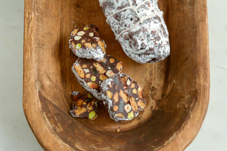 Chocolate Ginger Salami with Hazelnuts sliced in an old wooden serving bowl