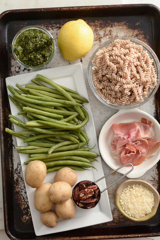 Ingredients needed for Pasta, Green Beans, and Potatoes with Kale Pesto on a sheet tray