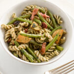 Pasta and Green Beans with Kale Pesto close up in a bowl with a fork