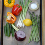 raw veggies on a tray for Charred Garden Vegetables with Herb Dressing recipe
