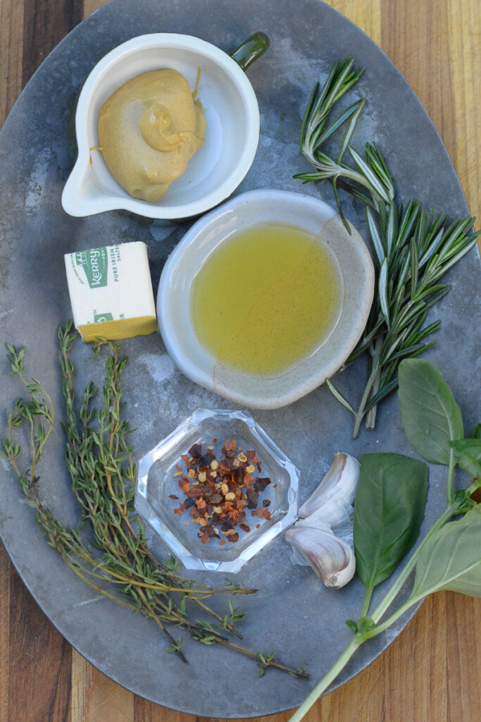 dressing ingredients on a sheet pan for charred vegetable recipe