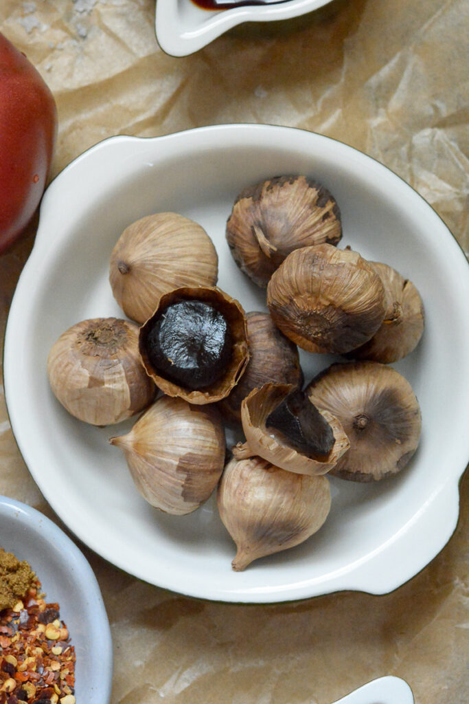 Overhead shot of black garlic in a dish