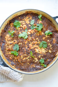 Top down shot of Summer Veg and Bean Enchilada Bake photo in pan