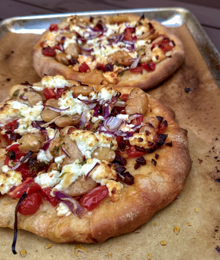 Marinated Corona Beans on a grilled pizza with goat cheese