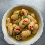 Marinated Corona Beans in a small bowl overhead shot